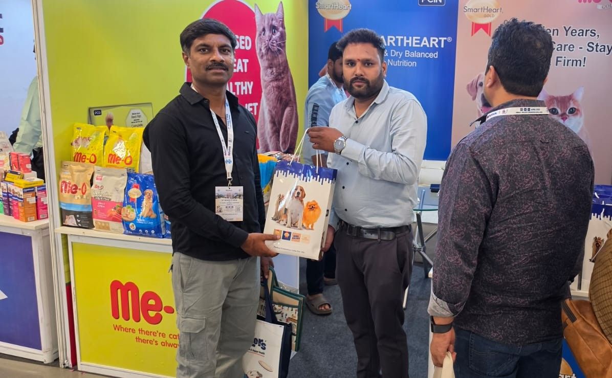 Pet nutrition exhibition booth with men demonstrating pet food products at WSAVA conference event